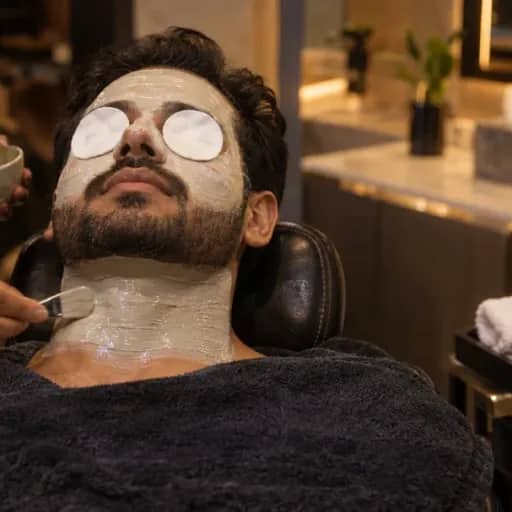 A premium de-tan treatment on the face and neck, with cotton pads over the eyes